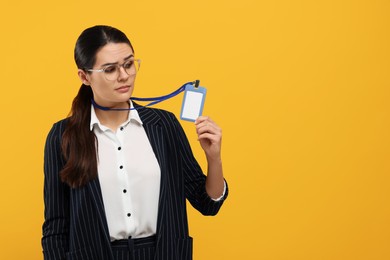 Woman with vip pass badge on orange background. Space for text