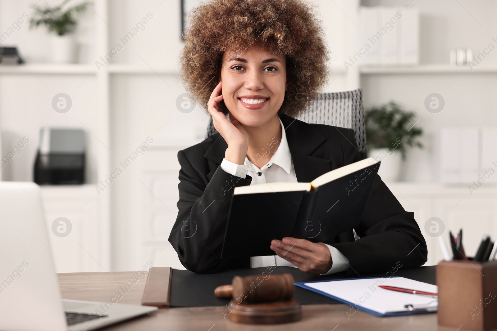 Photo of Notary with notebook at workplace in office