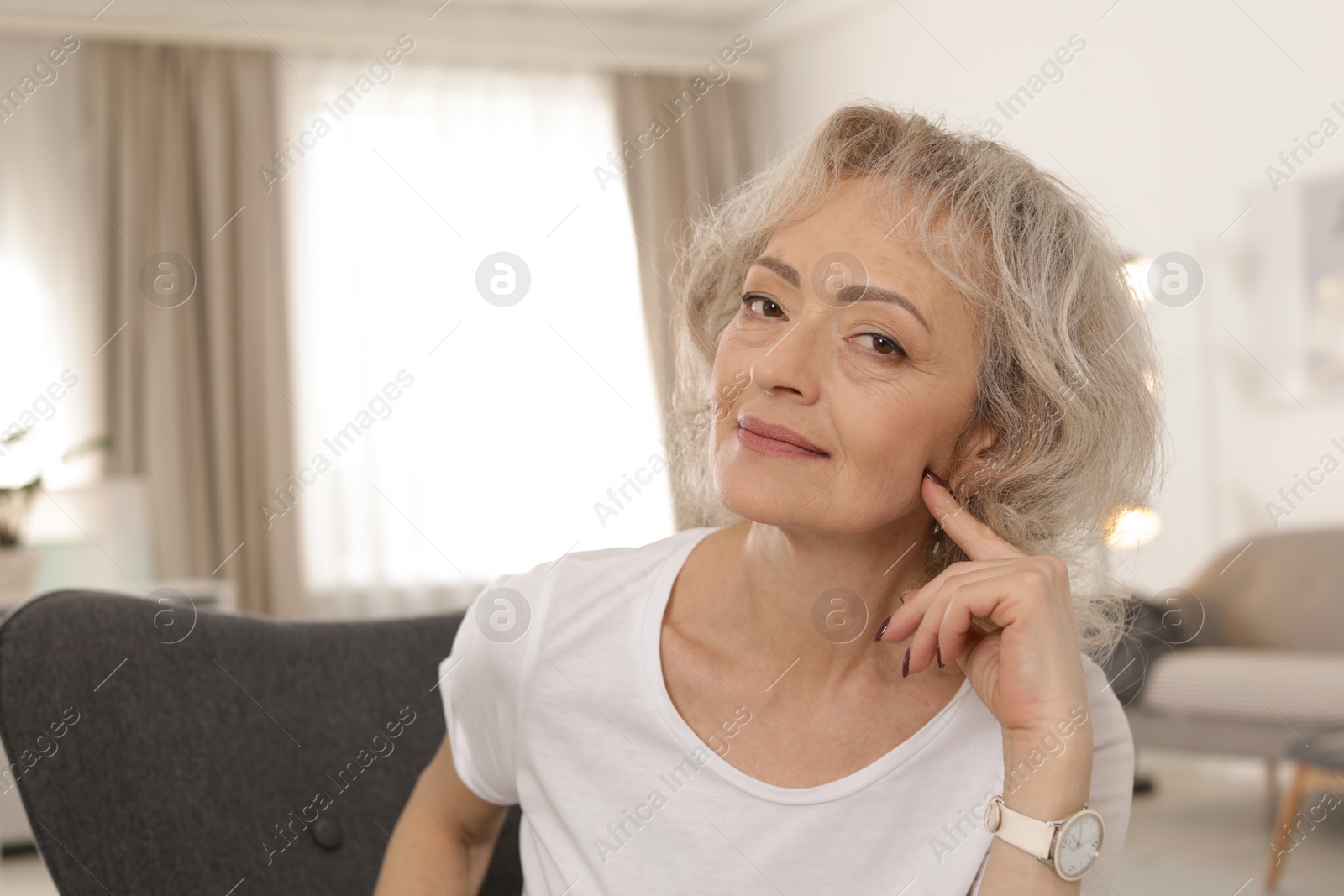 Photo of Portrait of mature woman in living room