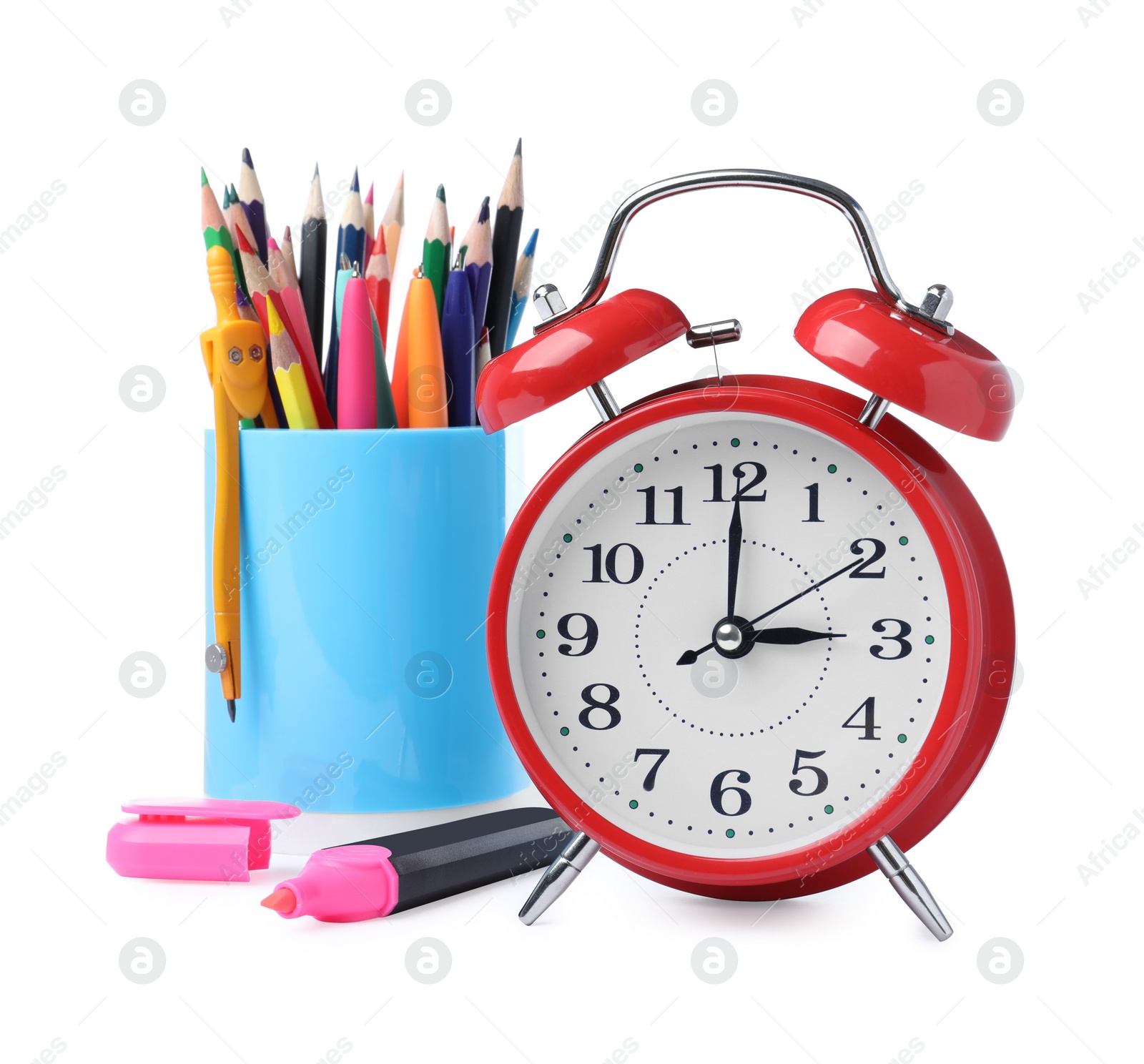 Photo of Red alarm clock and different stationery on white background. School time