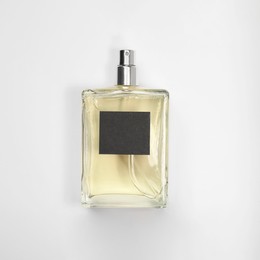 Photo of Luxury men's perfume in bottle on white background, top view