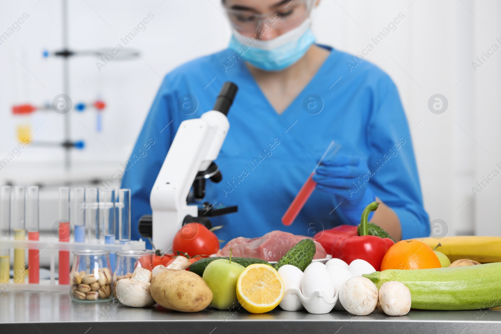 Photo of Scientist checking products at table in laboratory. Quality control