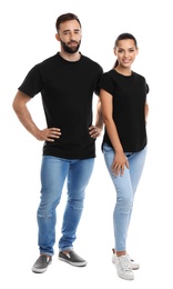 Photo of Young couple in t-shirts on white background. Mockup for design