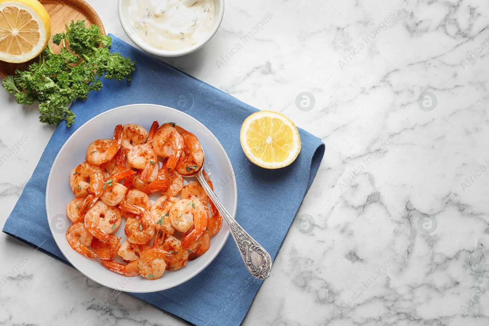 Photo of Bowl with delicious fried shrimps on table, top view