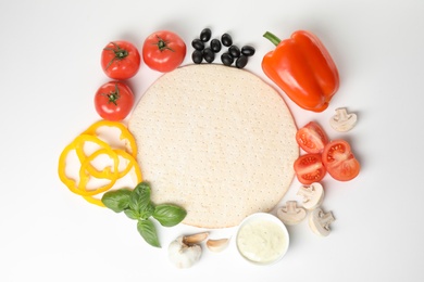 Photo of Composition with pizza crust and fresh ingredients isolated on white, top view