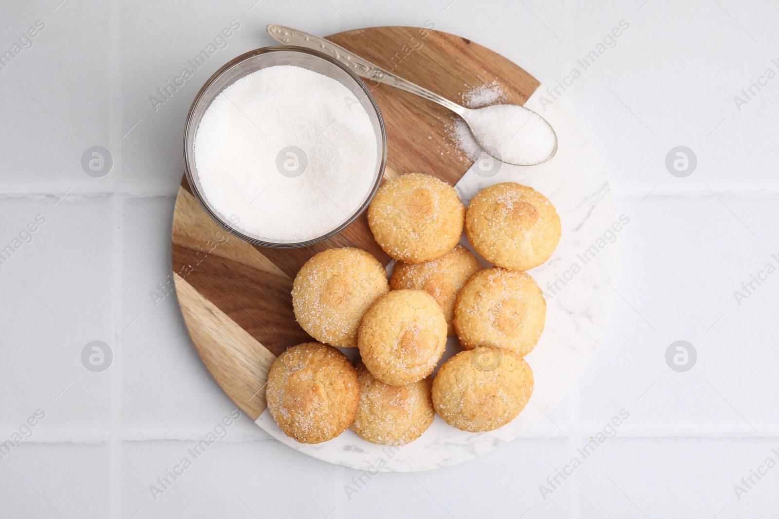 Photo of Tasty sweet sugar cookies on white tiled table, top view