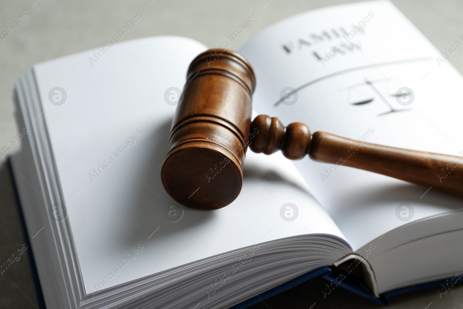 Photo of Wooden gavel and book on table, closeup. Law concept