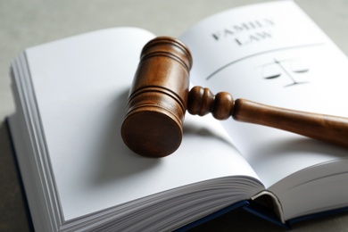 Wooden gavel and book on table, closeup. Law concept