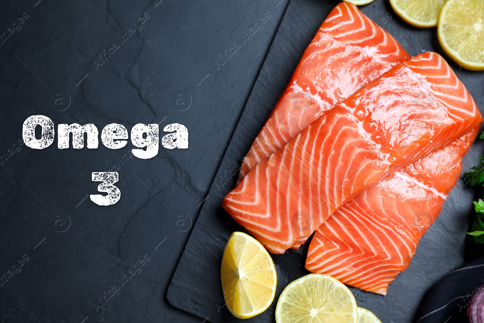 Image of Omega 3. Fresh cut salmon and lemon on black table, top view