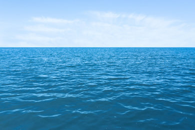 Image of Beautiful ripply sea under blue sky with clouds