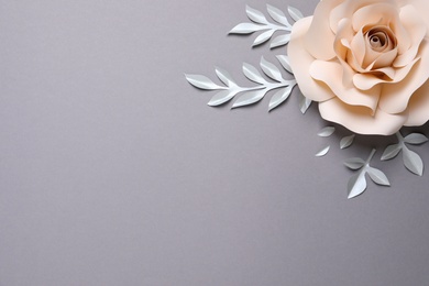 Beautiful beige flower and branches made of paper on grey background, flat lay. Space for text