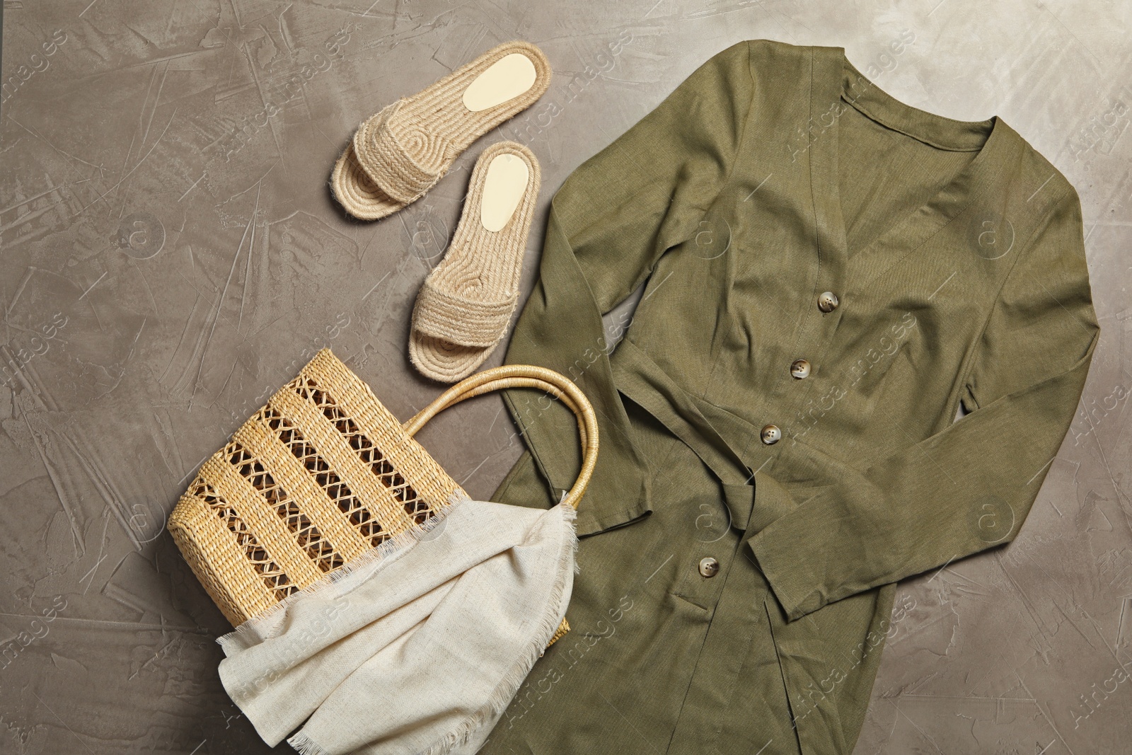 Photo of Stylish dress, bag and shoes on grey stone background, flat lay