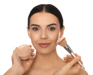 Photo of Professional makeup artist applying powder onto beautiful young woman's face with brush on white background