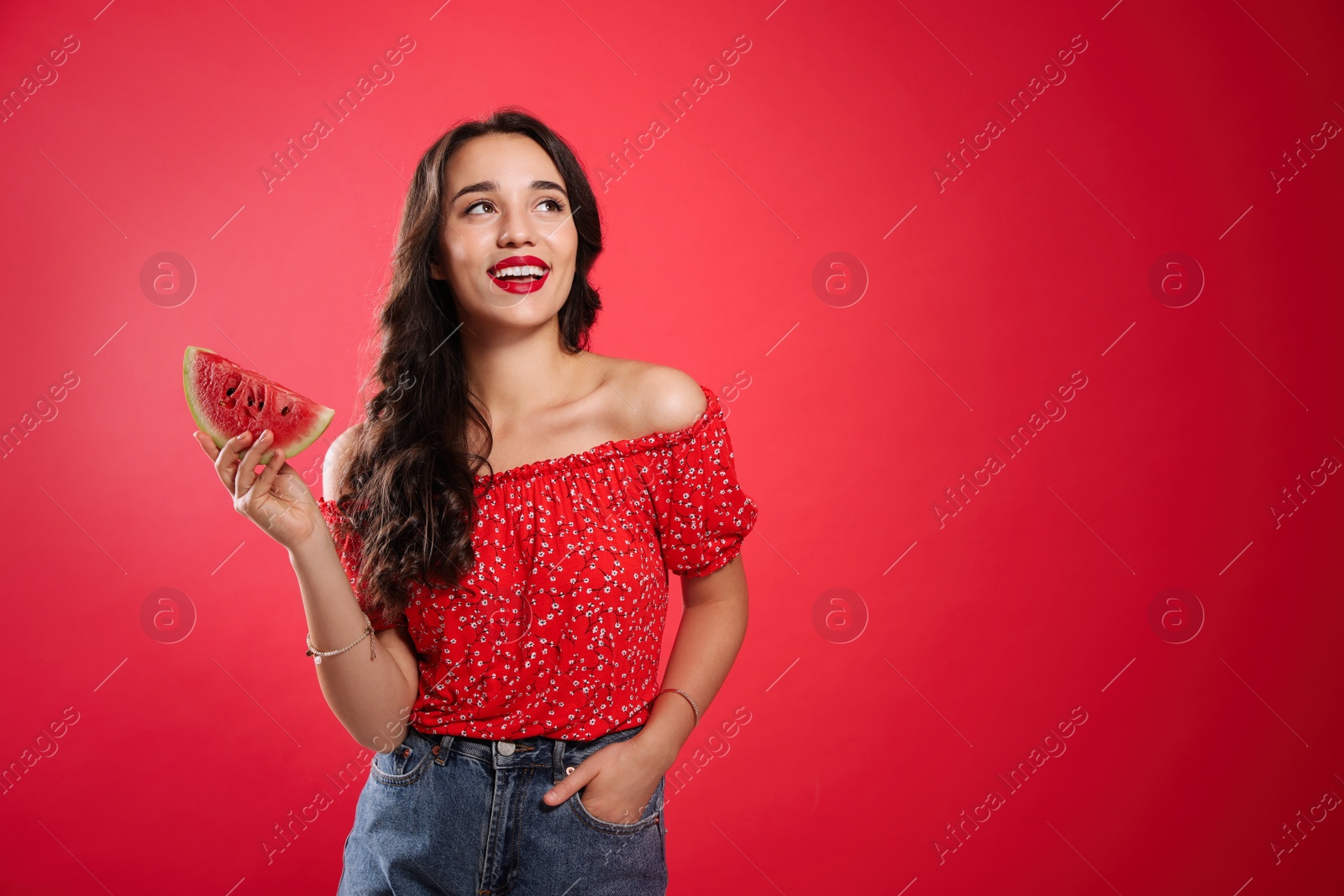 Photo of Beautiful young woman with watermelon on red background. Space for text