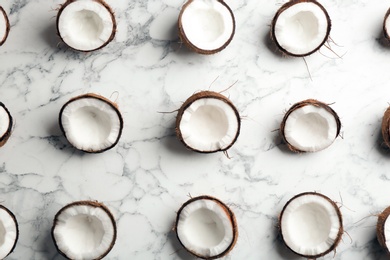 Photo of Coconut pattern on marble background, flat lay