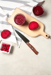 Flat lay composition with beet smoothies on light background. Space for text