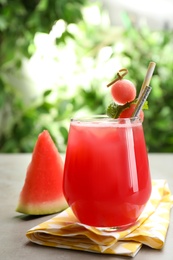 Photo of Delicious fresh watermelon drink on grey table