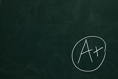 Image of School grade. Letter A with plus symbol on green chalkboard