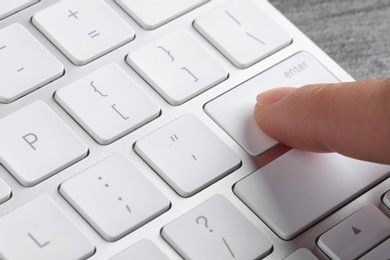 Photo of Woman pressing button on computer keyboard, closeup