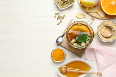 Flat lay composition with immunity boosting drink on white wooden table. Space for text