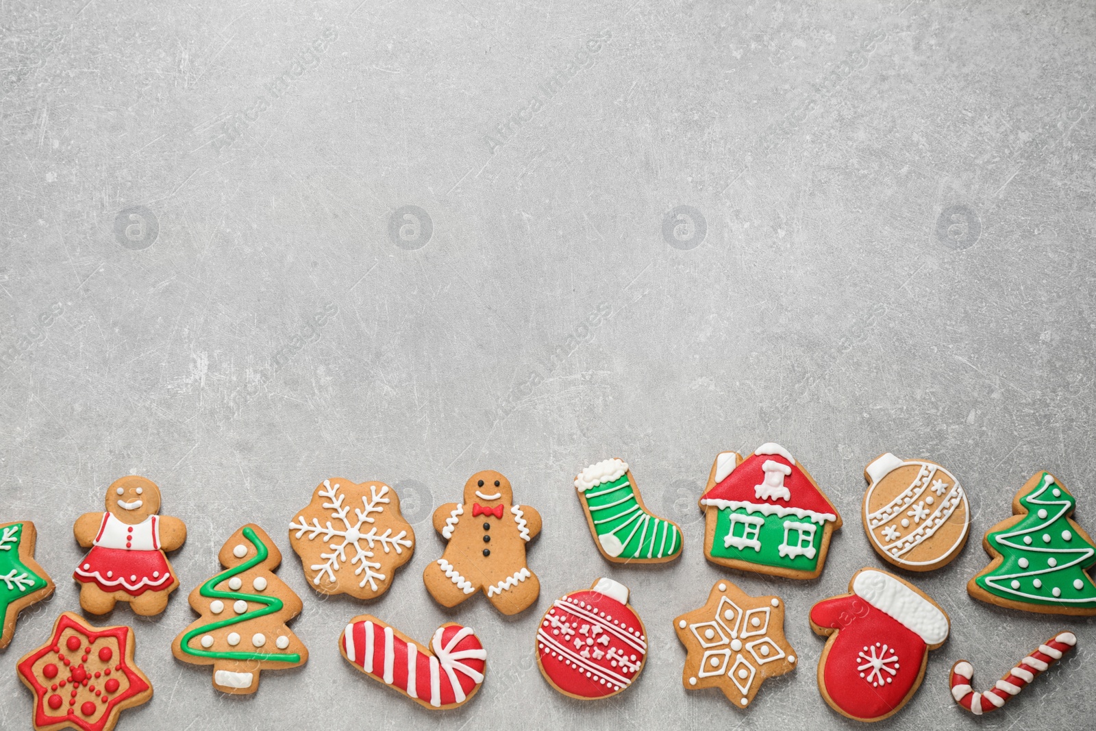 Photo of Flat lay composition with tasty homemade Christmas cookies on grey table, space for text