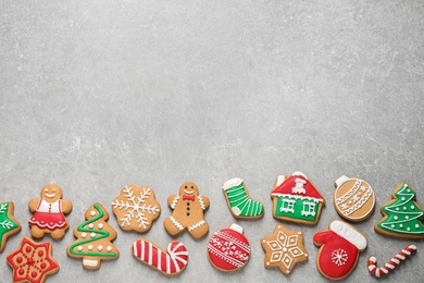 Flat lay composition with tasty homemade Christmas cookies on grey table, space for text