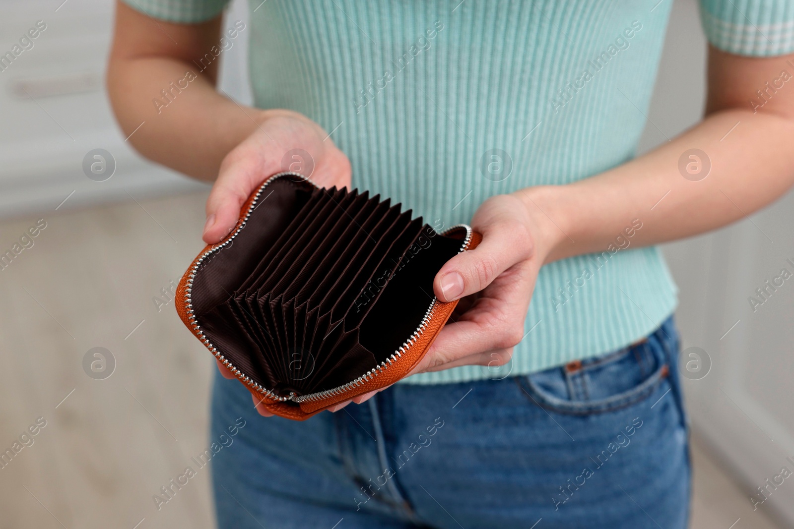 Photo of Woman with empty wallet at home, closeup