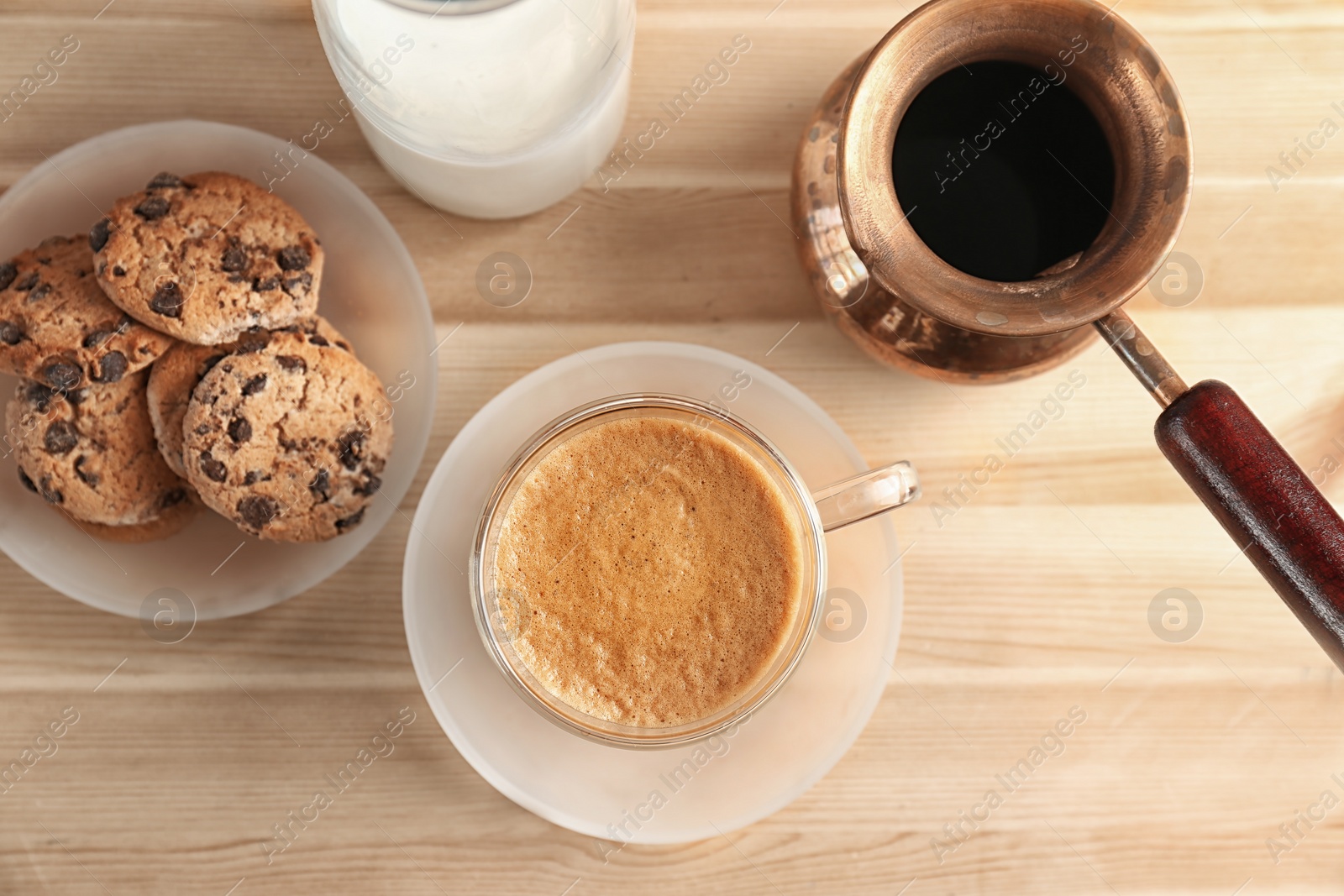 Photo of Glass cup of aromatic hot coffee on wooden table