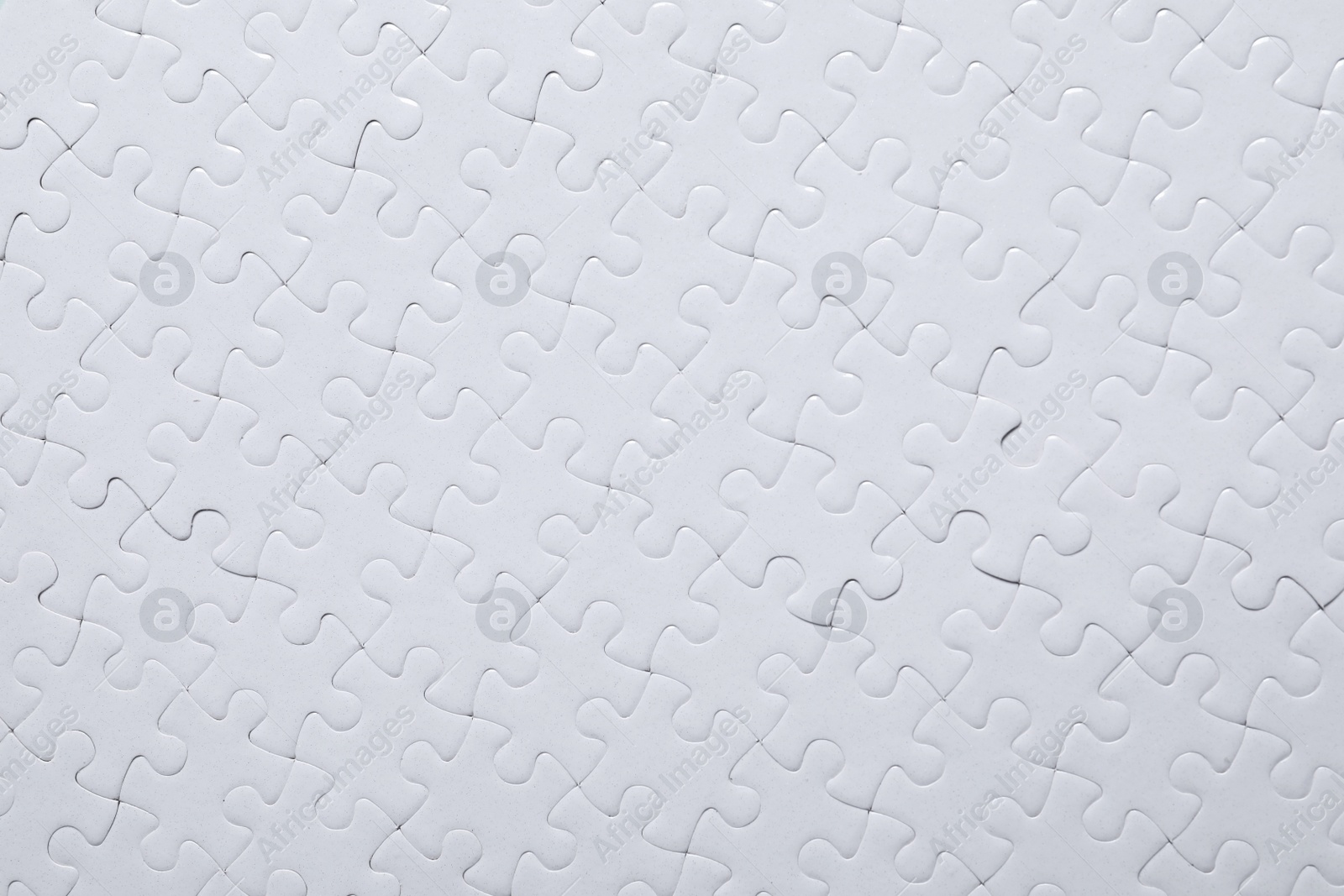 Photo of Blank white puzzle as background, top view