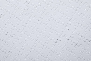 Blank white puzzle as background, top view