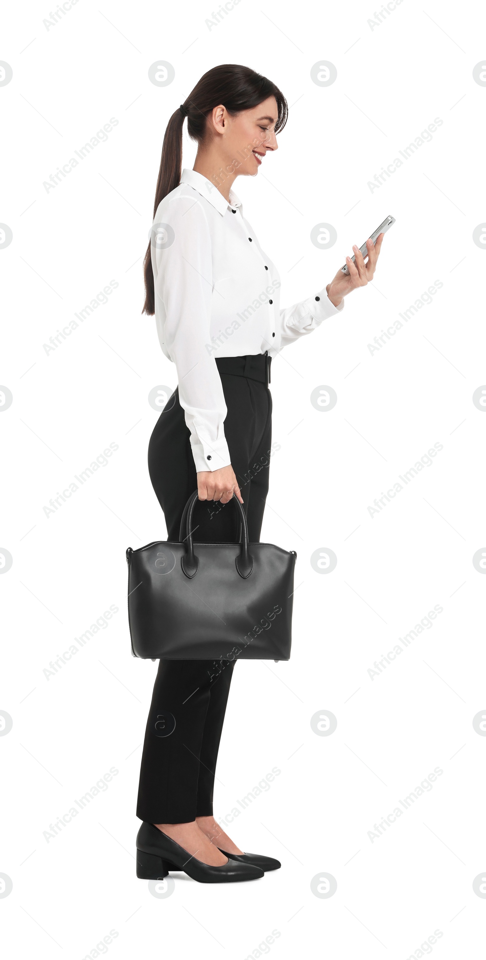 Photo of Happy businesswoman with bag using smartphone on white background