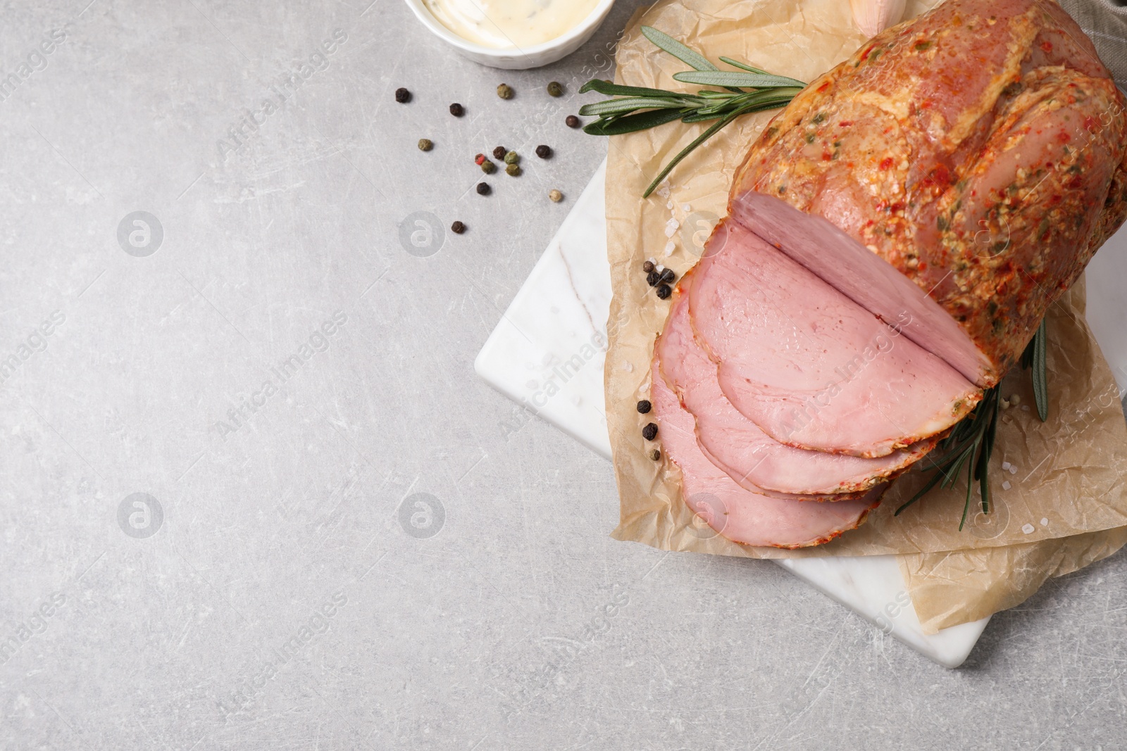 Photo of Delicious ham served on grey table, flat lay. Space for text