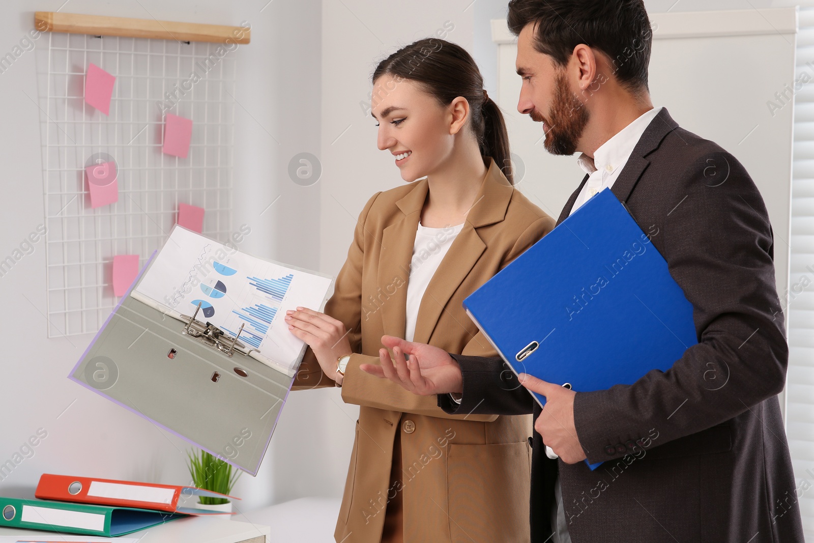Photo of Businesspeople working together with charts in office