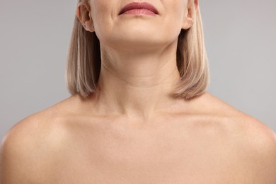 Woman with healthy skin on grey background, closeup