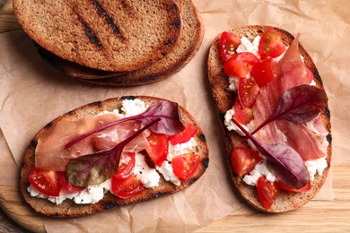 Flat lay composition with tasty bruschettas on serving board