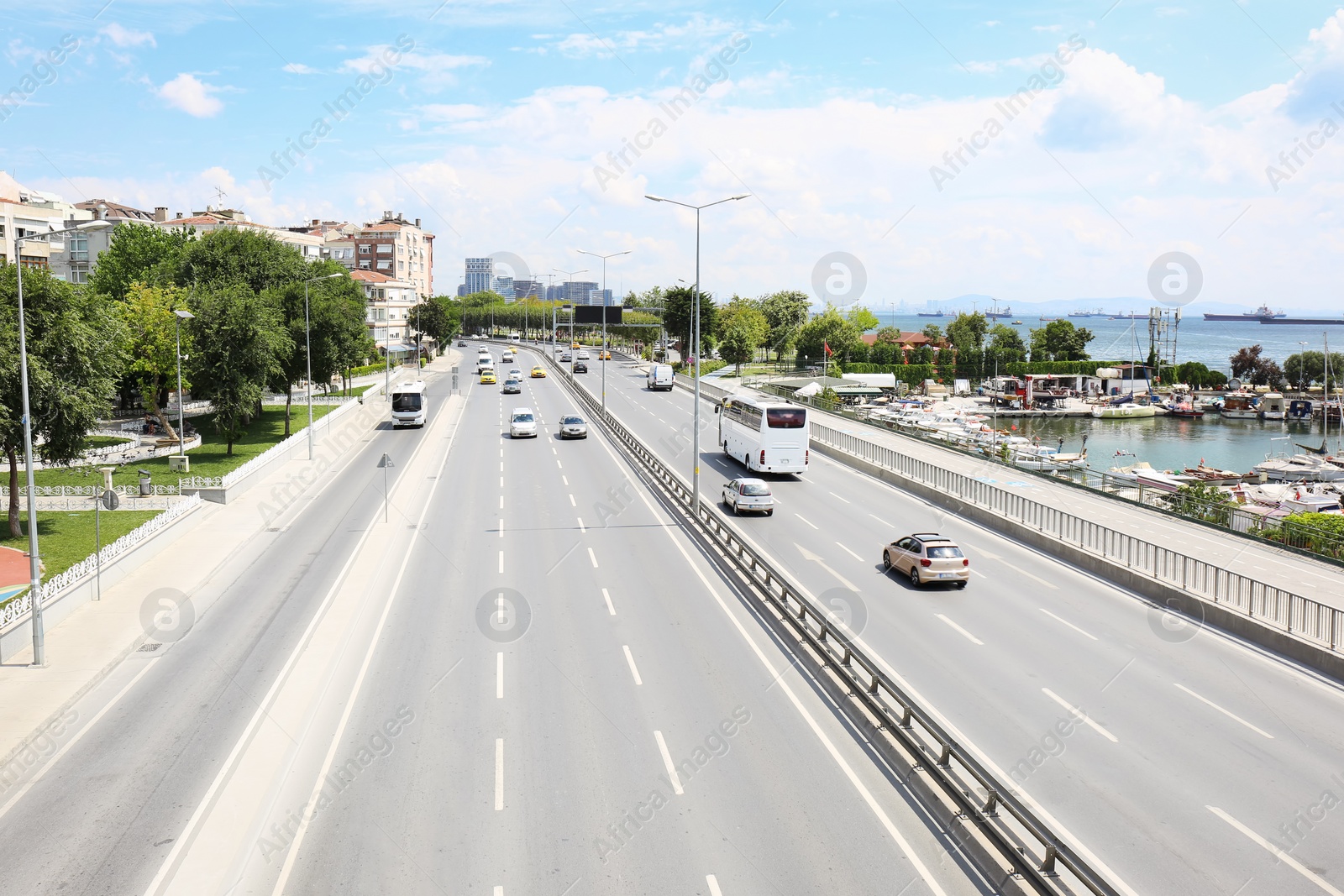 Photo of Beautiful city street with cars near sea