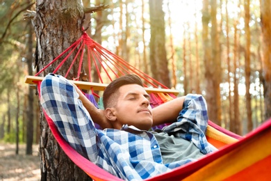 Man resting in hammock outdoors on summer day