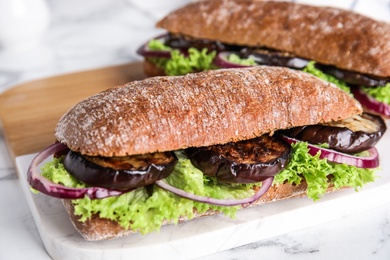 Photo of Delicious fresh eggplant sandwiches served on white table, closeup