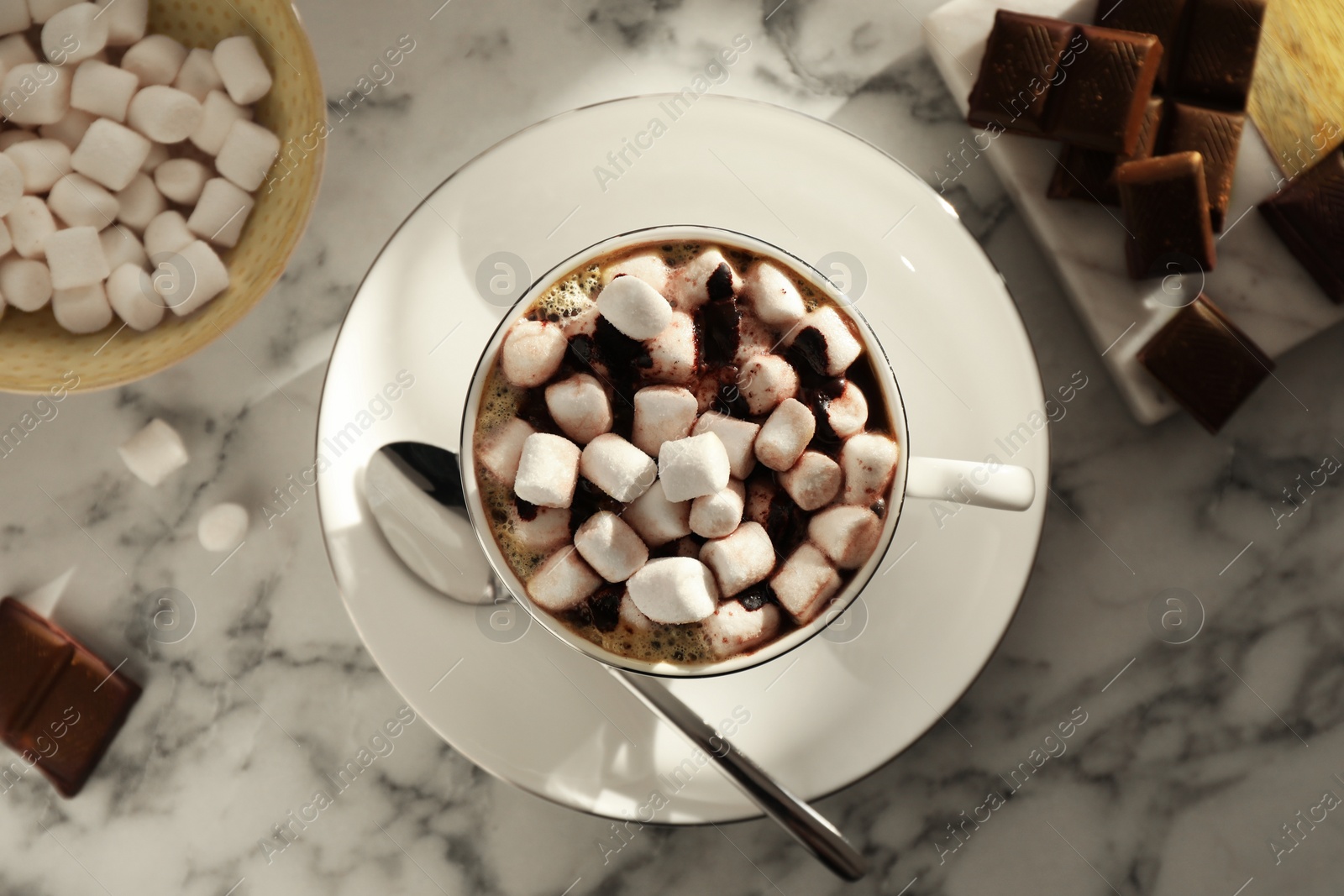 Photo of Cup of aromatic hot chocolate with marshmallows served on light marble table, flat lay