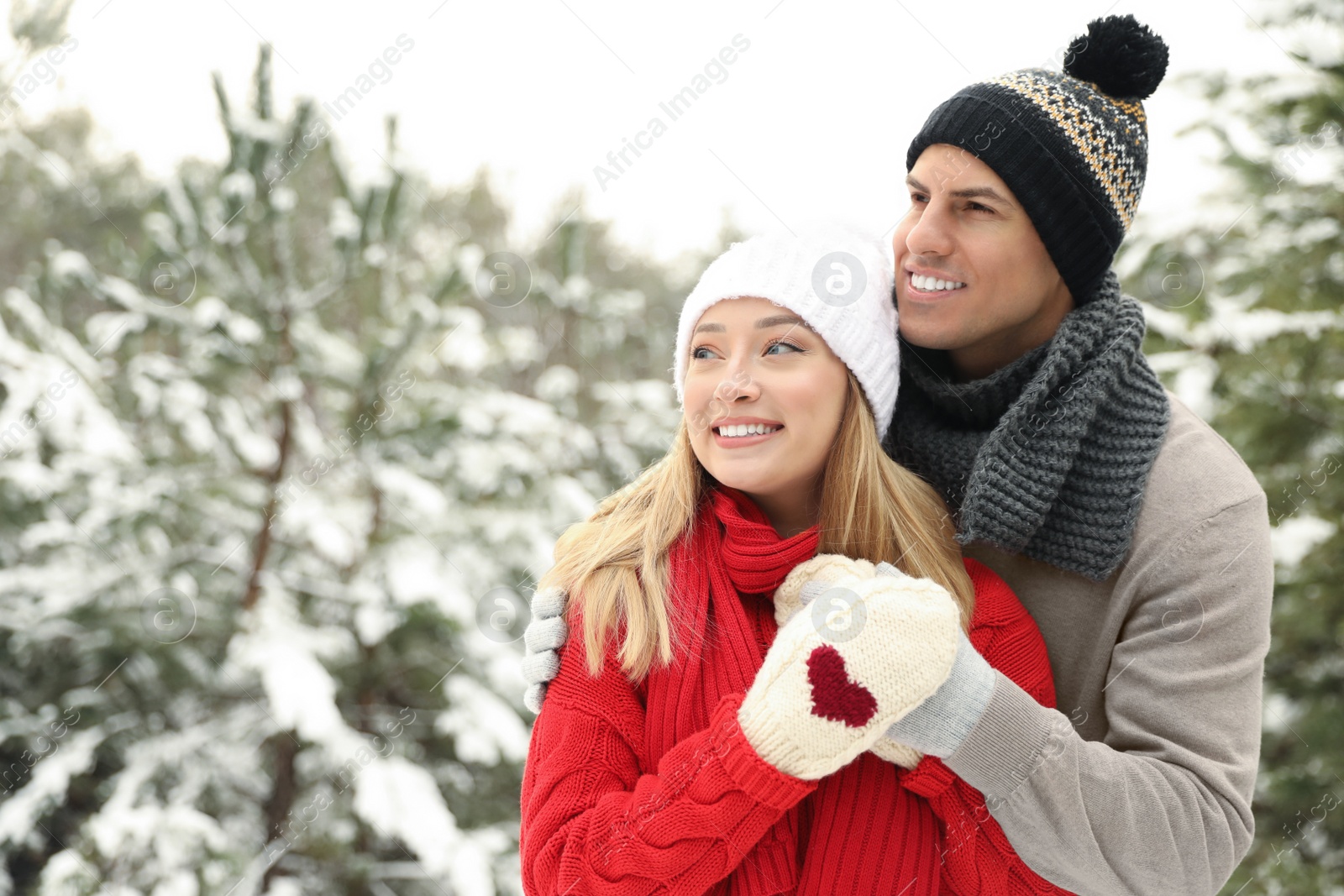 Photo of Beautiful happy couple in snowy forest on winter day