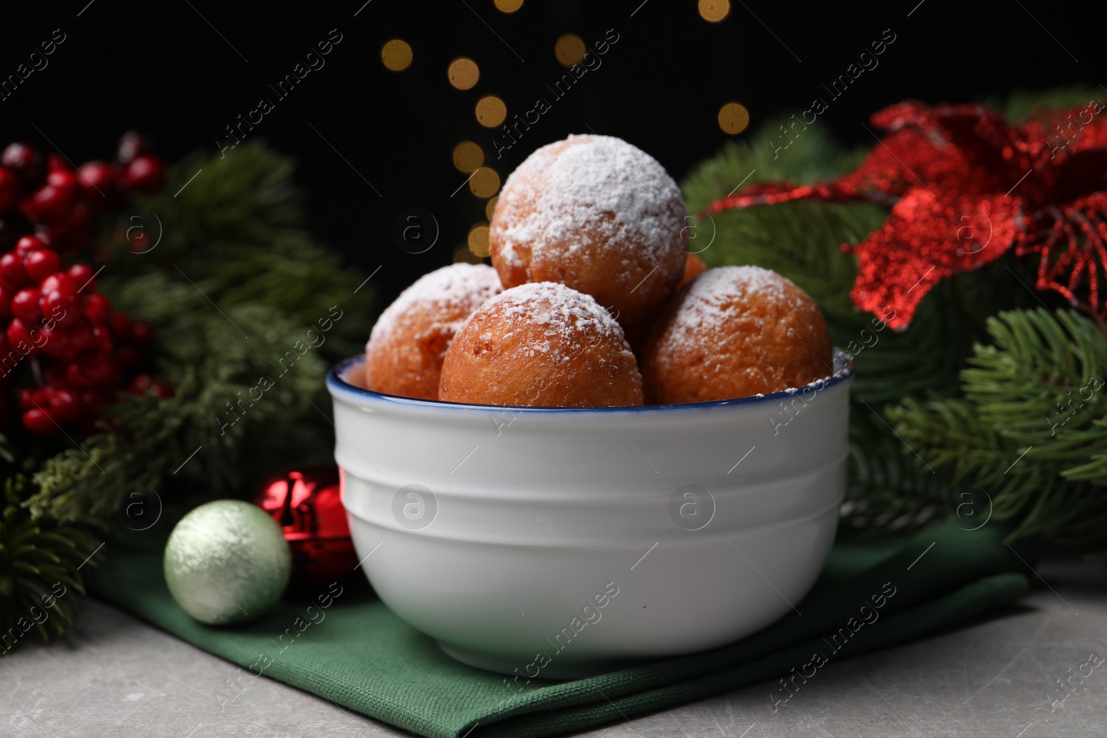 Photo of Delicious sweet buns in bowl and decor on table, closeup