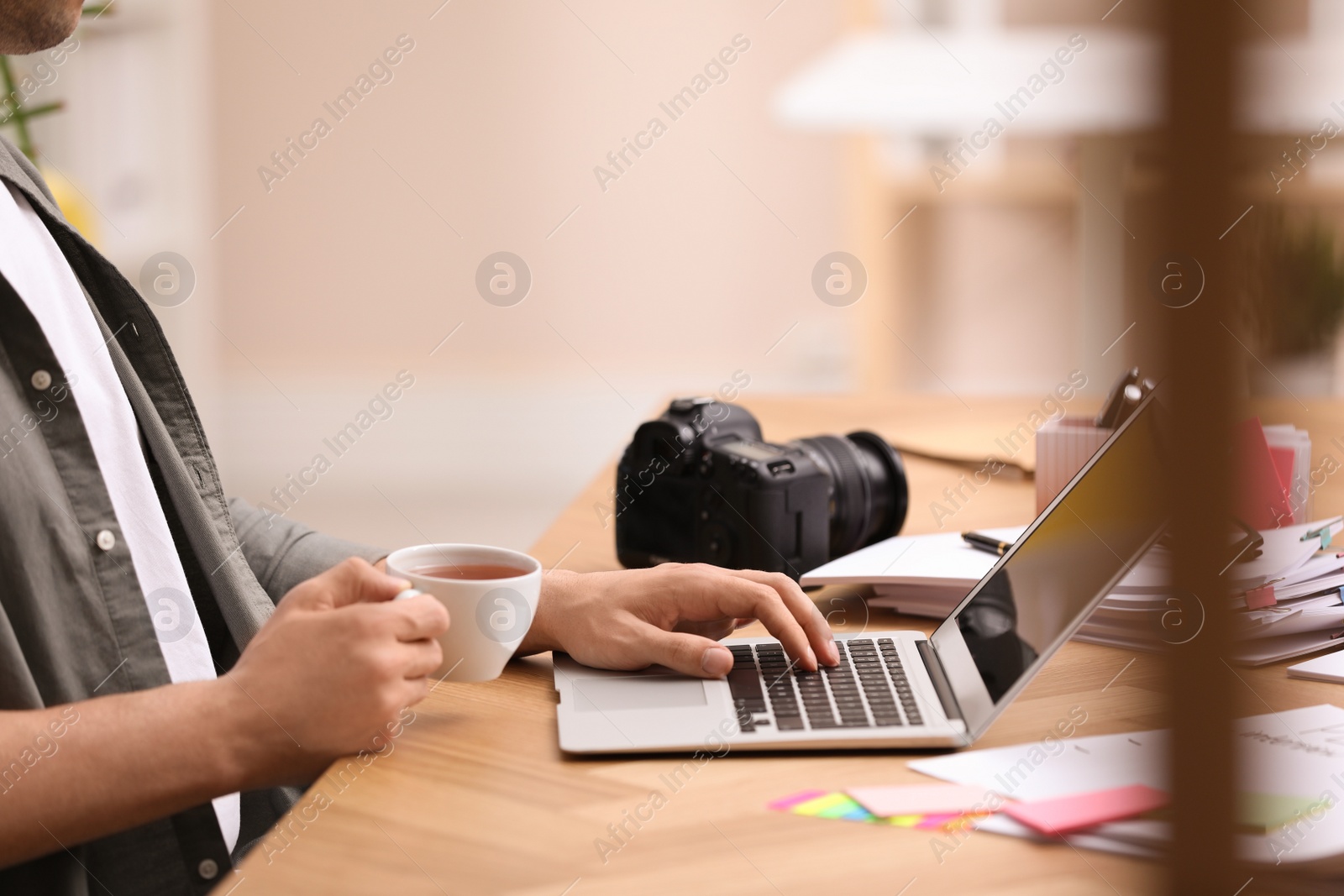 Photo of Professional journalist working with laptop in office, closeup