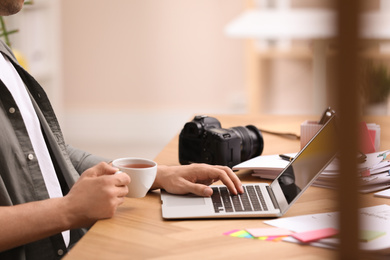 Professional journalist working with laptop in office, closeup