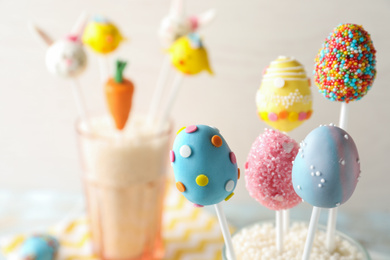 Photo of Egg shaped cake pops on light background, space for text. Easter celebration
