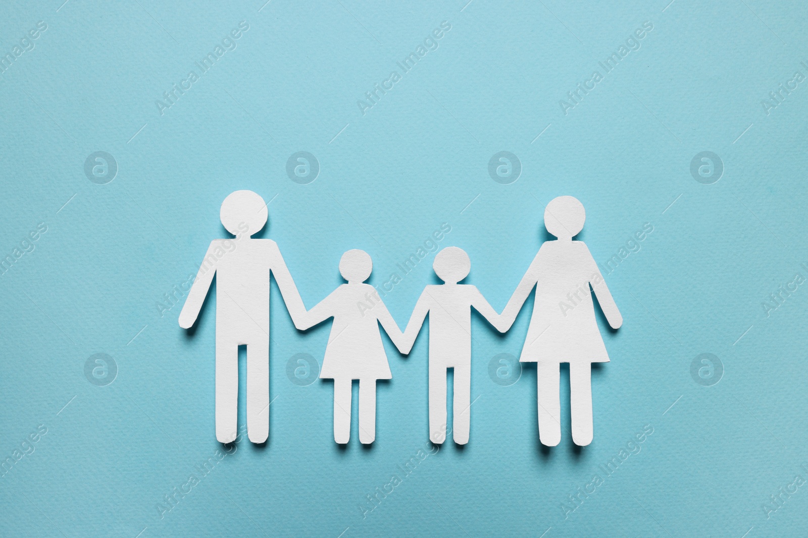 Photo of Paper family figures on light blue background, top view. Insurance concept