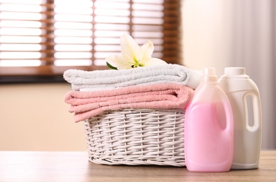 Basket with towels and detergents on table in room