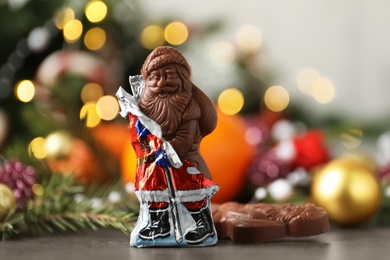 Chocolate Santa Claus candies on grey table