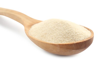 Spoon with organic semolina on white background, closeup