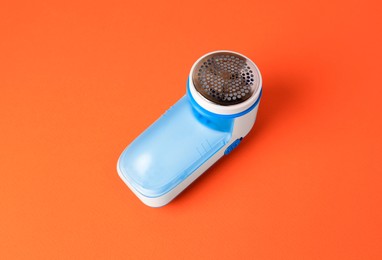 Photo of Fabric shaver on orange background, above view