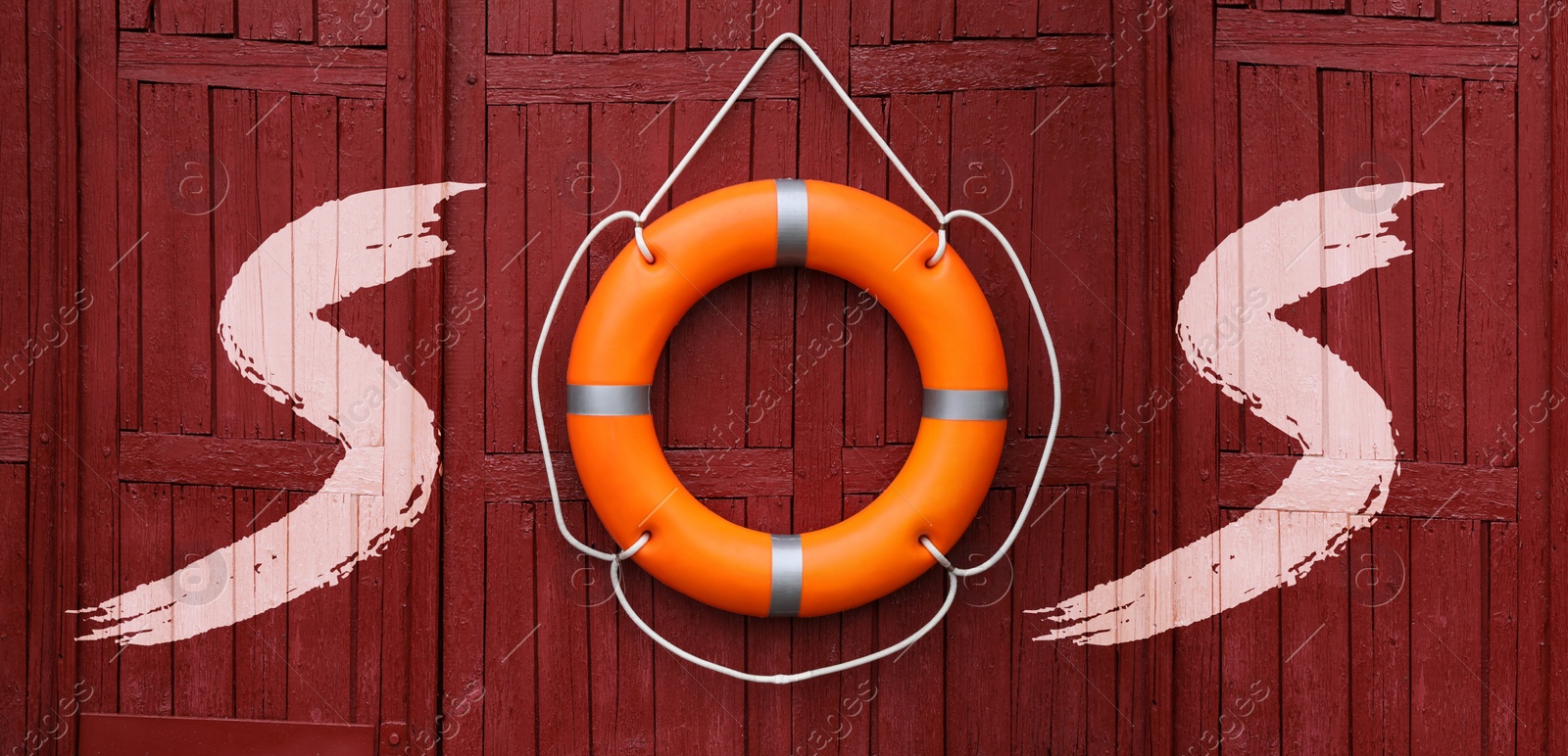 Image of SOS message made from lifebuoy and letters on red wooden wall. Banner design